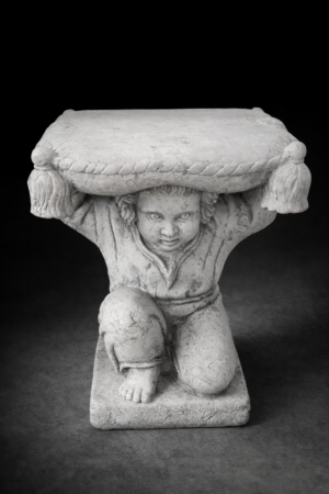 Sgabello in marmo con putto inginocchiato che regge un cuscino